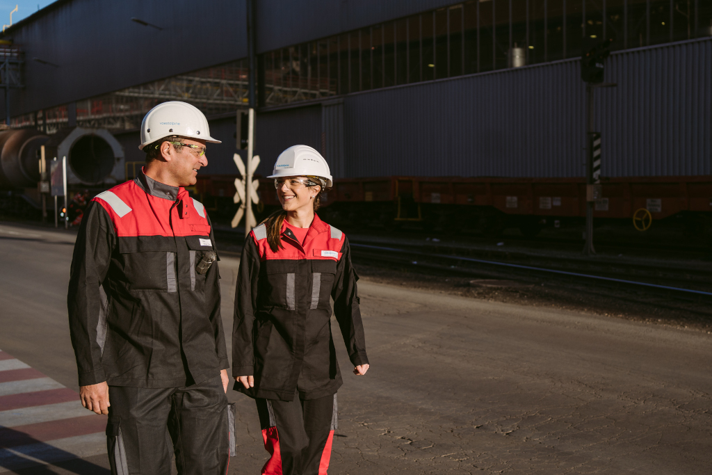 Employee, father and daughter with work clothes and helmet on the voestalpine Donawitz site