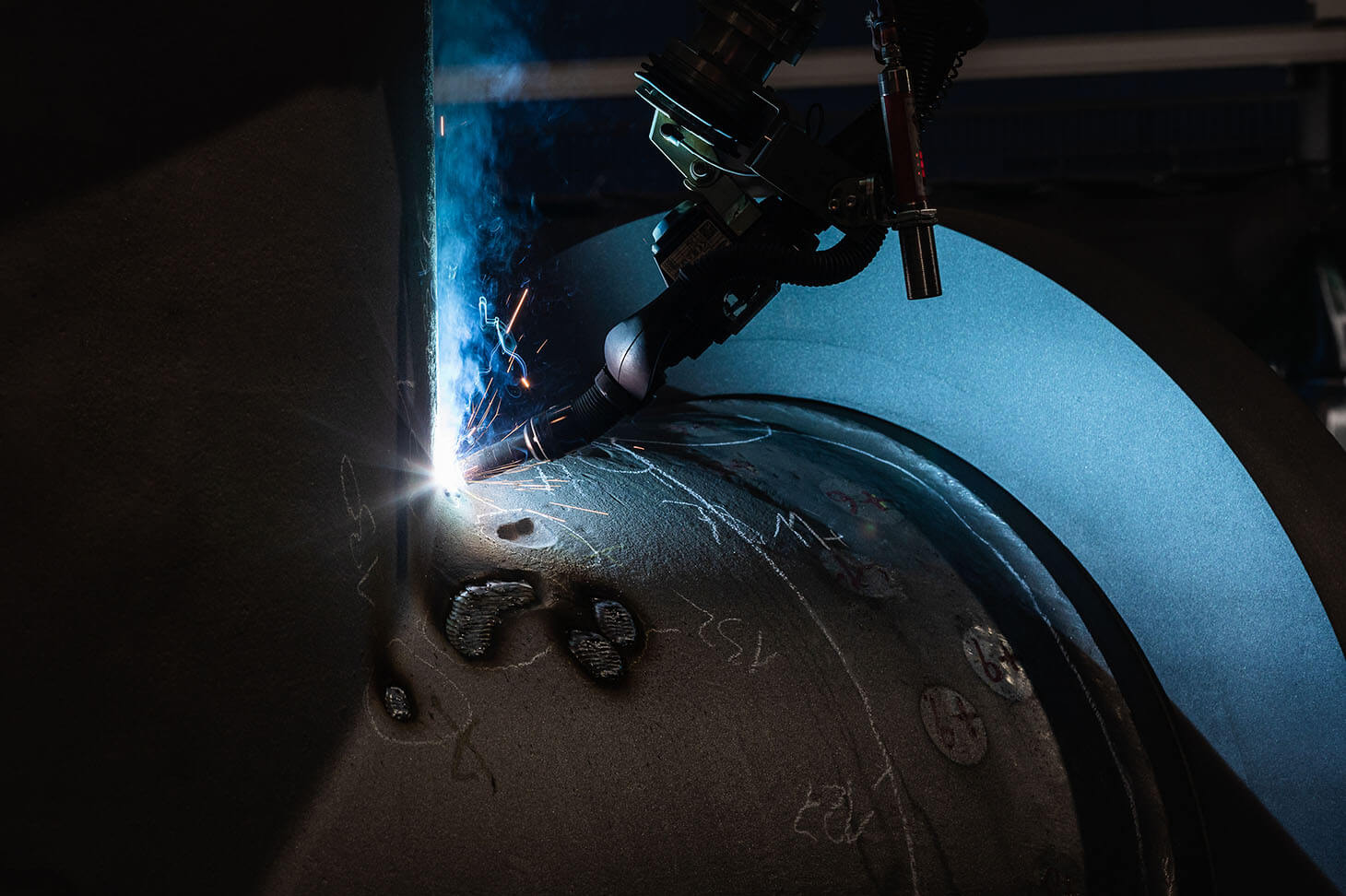 Close-up of robot welding system at work on a weld seam