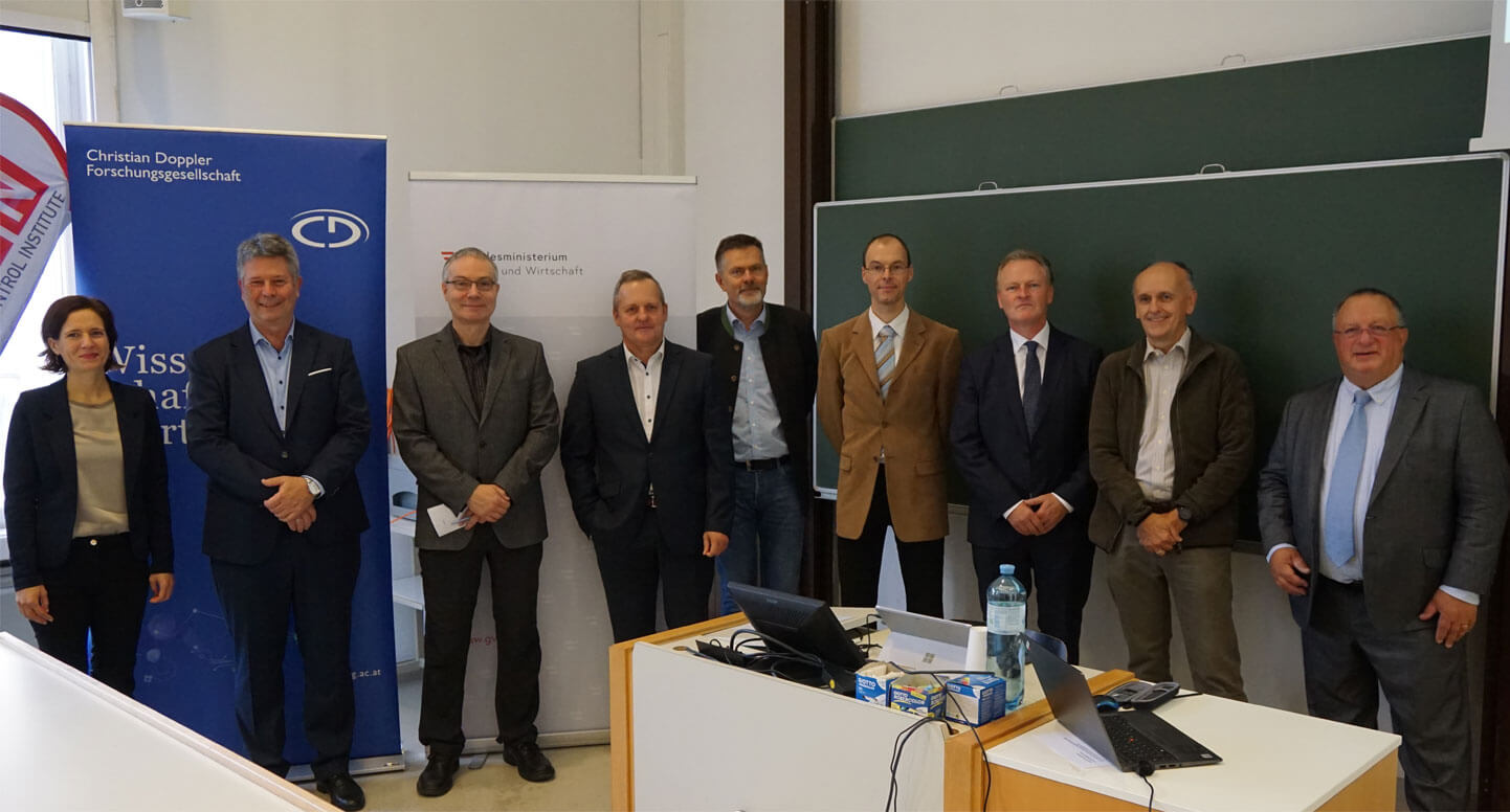Group photo of 9 people at the Vienna University of Technology