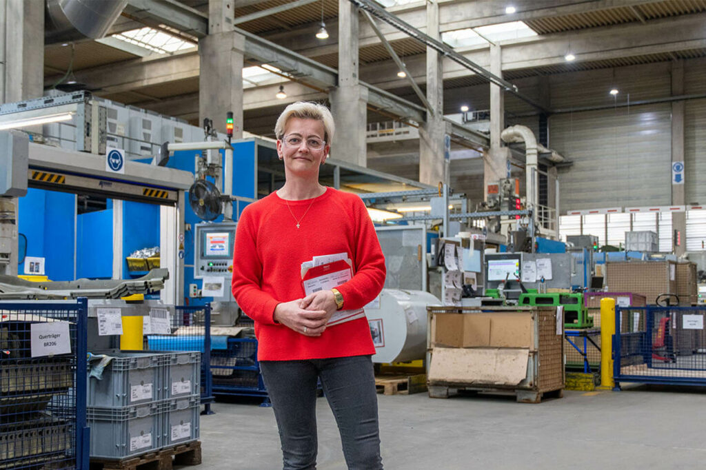 Fabienne in the factory hall of voestalpine Automotive Components