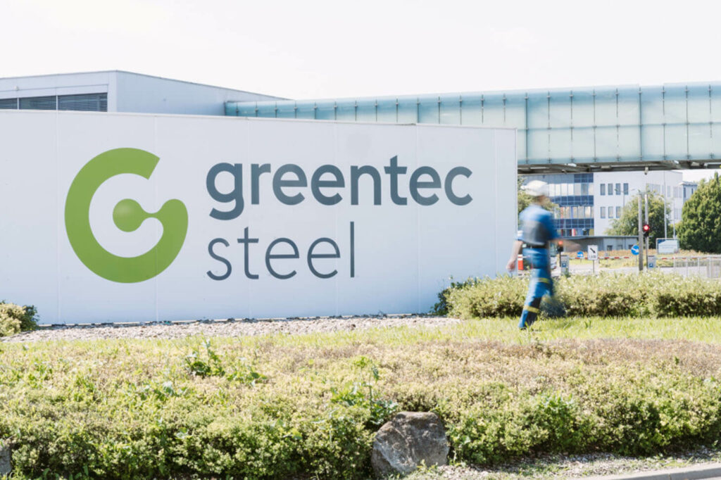 greentec steel sign with an employee in front of it