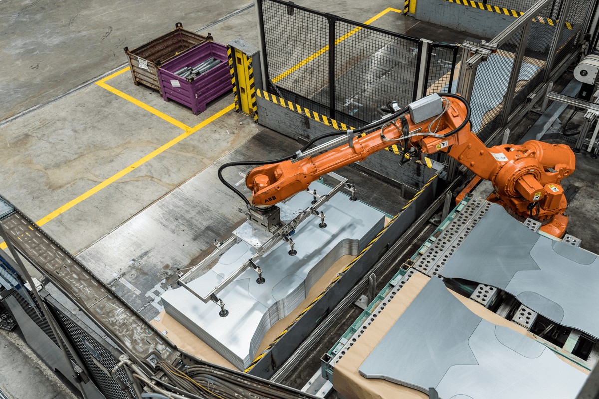 voestalpine robot for stacking steel plates in a factory hall photographed from above