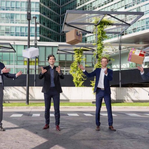Team photo of 4 Global Supply Chain Managers with parcels thrown in the air