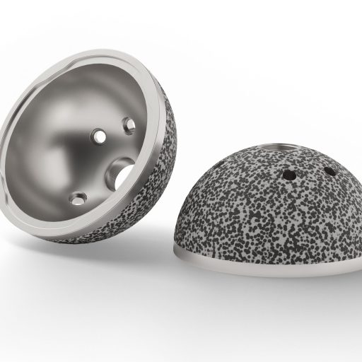 Two hemispherical medical implant components with textured metal surfaces on a white background.