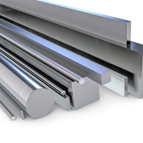 A variety of shiny tool steel rods and bars in different shapes and sizes, including cylindrical and rectangular forms, arranged side by side on a reflective surface.