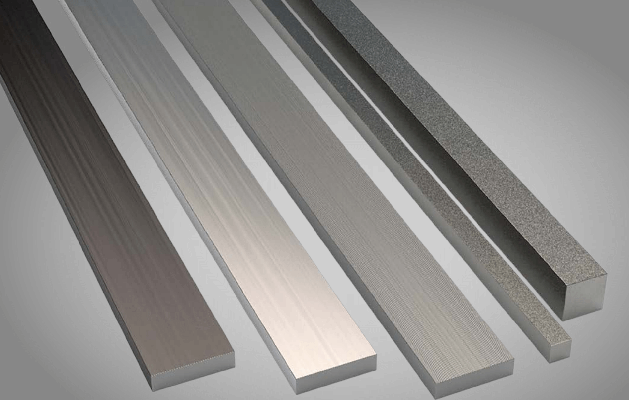 Five metal bars, resembling knive steel blanks of different widths and surface finishes, are arranged vertically against a gray background, showcasing smooth, brushed, and textured appearances.