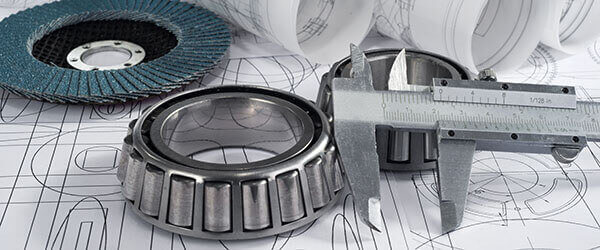Mechanical engineering drawing with some tools and metals parts.