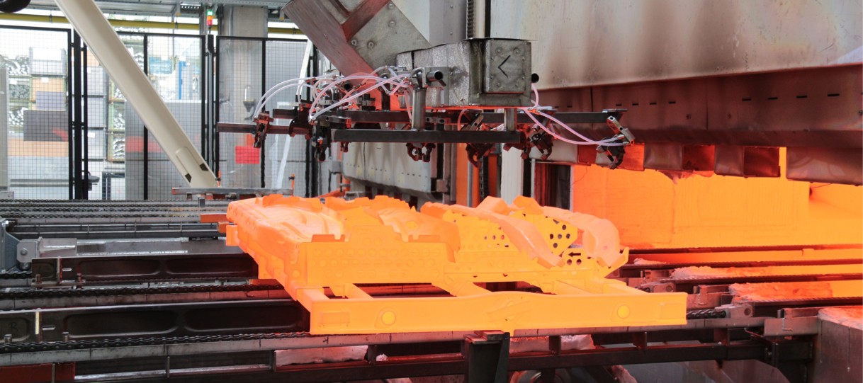 Continuous induction furnace for austenitizing automotive body components during hot forming