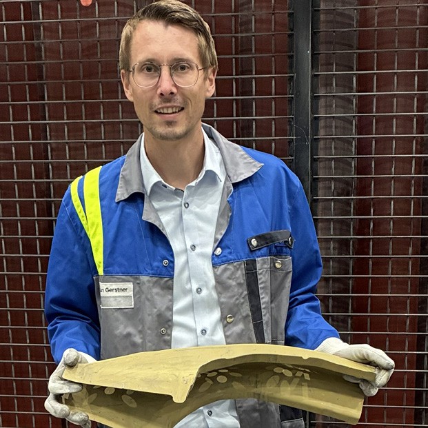 Florian Gerstner, head of the Tec Center at voestalpine Automotive Components, holding an unfinished car body part