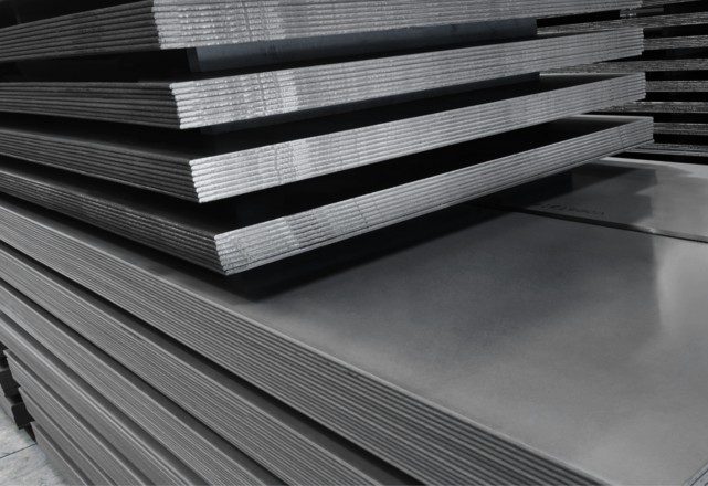 Stacked durostat steel plates in various sizes in an industrial warehouse area